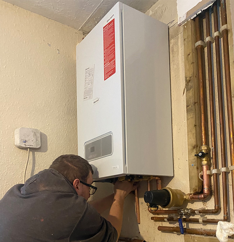 Gas Safe engineer repairing a Glow-worm boiler